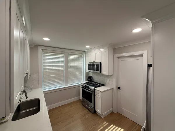 a kitchen with a refrigerator and a sink