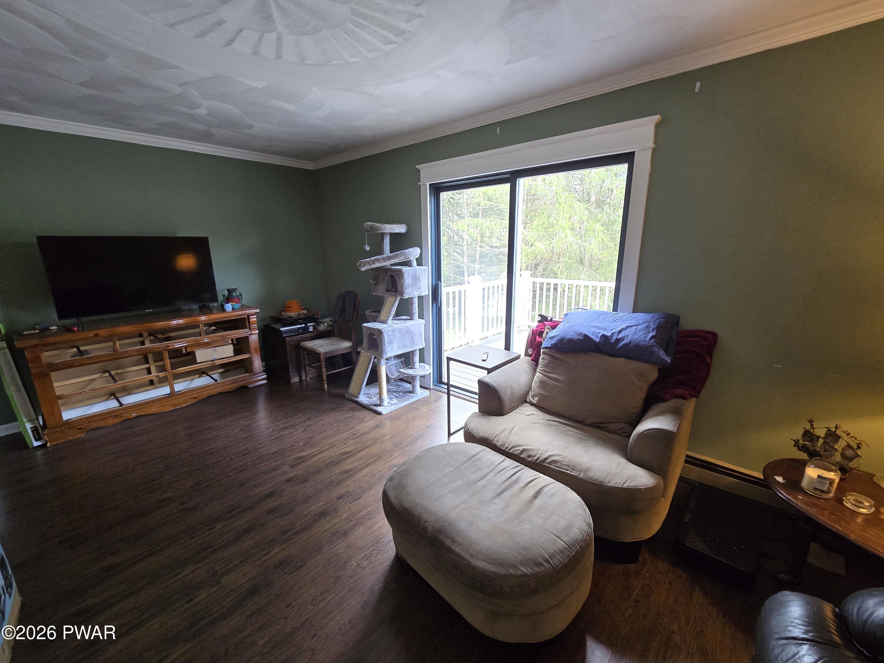 107 Keystone Hls Road, Unit 404 Factoryville, PA 18419 - Photo 2 of 23 a living room with furniture and a flat screen tv