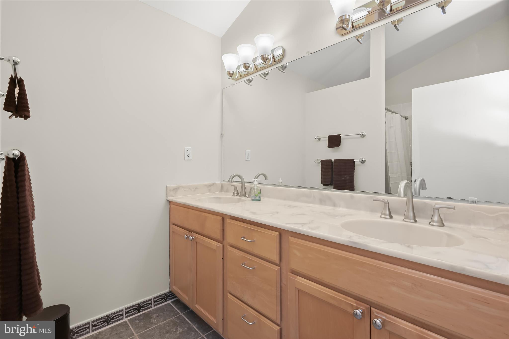 6910 Pindell School Road Clarksville, MD 21029 - Photo 38 of 73 a bathroom with a double vanity sink and a mirror