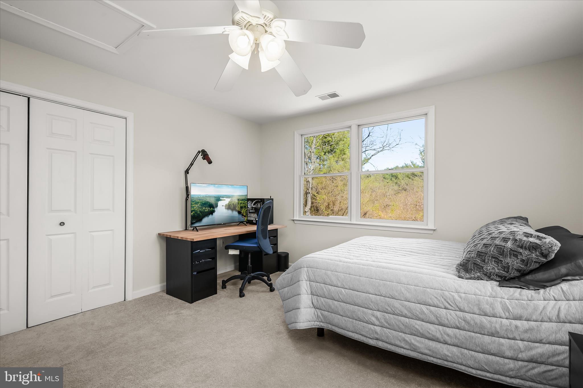 6910 Pindell School Road Clarksville, MD 21029 - Photo 45 of 73 a bedroom with a bed and a chandelier