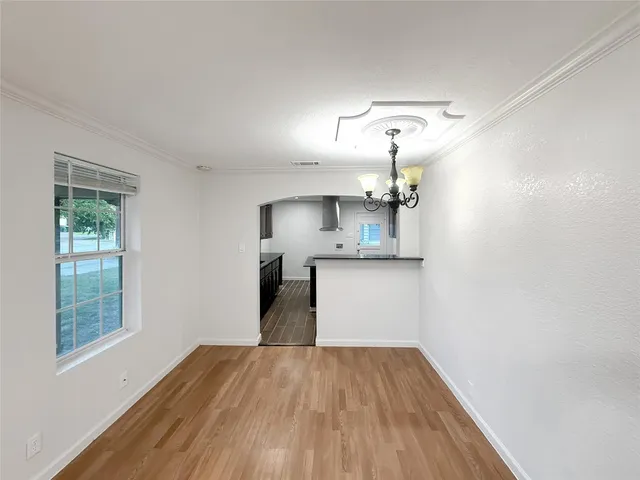 a view of a kitchen with a sink and wooden floor