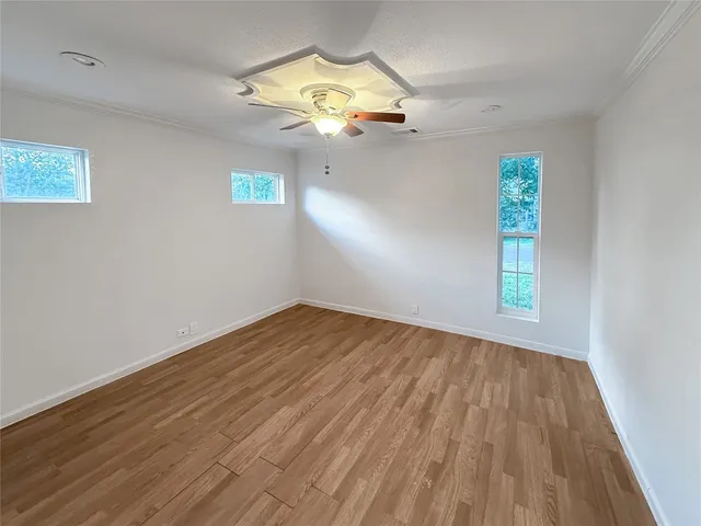 wooden floor in an empty room with a window