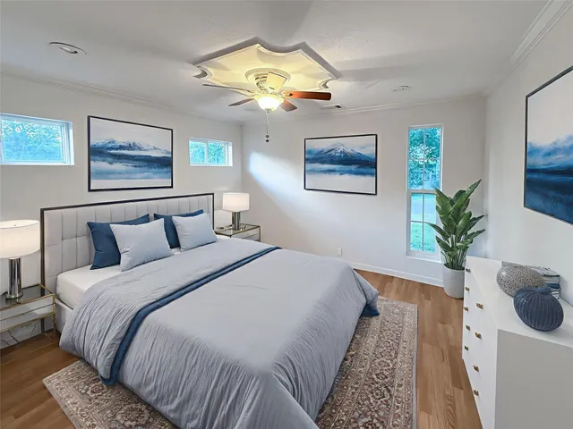 a bedroom with bed and a painting on the wall