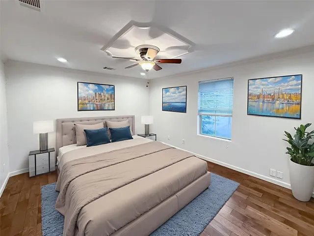 a spacious bedroom with a large bed and a chandelier