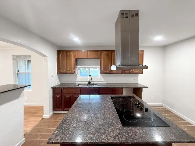 a kitchen with stainless steel appliances granite countertop a sink stove and cabinets