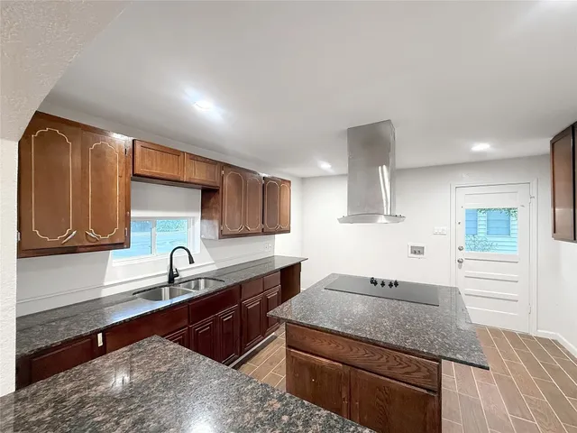 a kitchen with a sink stove and cabinets