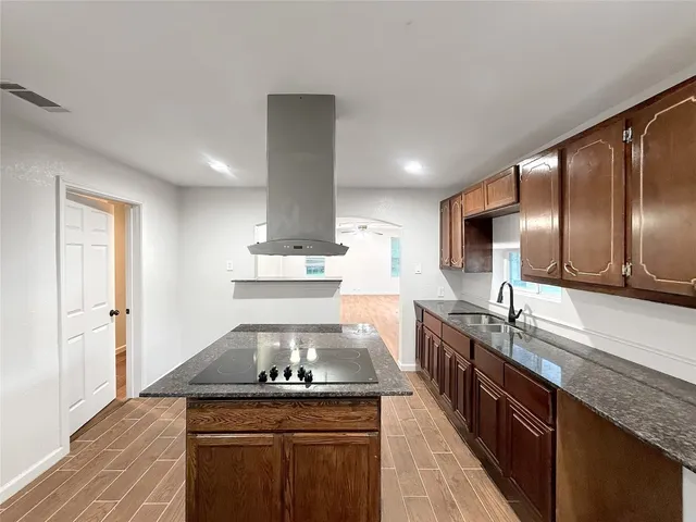 a kitchen with stainless steel appliances granite countertop a stove and a sink