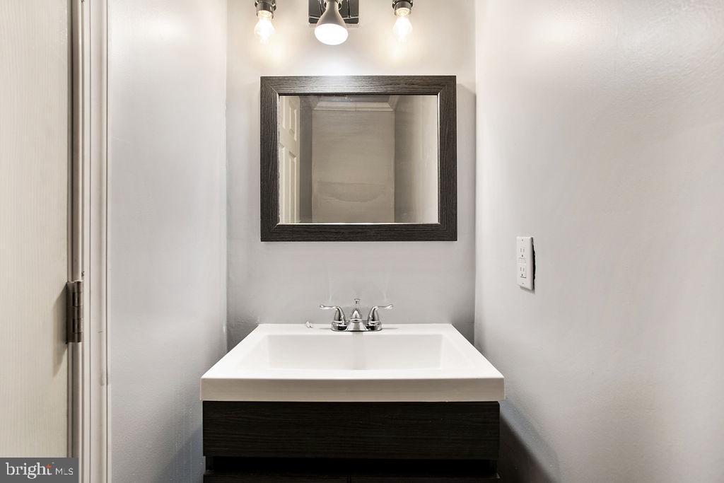 917 North Rose Street Baltimore, MD 21205 - Photo 12 of 34 a bathroom with a sink and a mirror