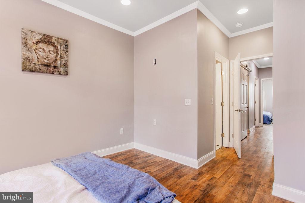 917 North Rose Street Baltimore, MD 21205 - Photo 16 of 34 a bedroom with a bed and a painting on the wall