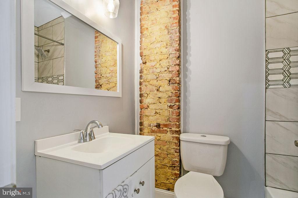 917 North Rose Street Baltimore, MD 21205 - Photo 20 of 34 a bathroom with a toilet sink and mirror