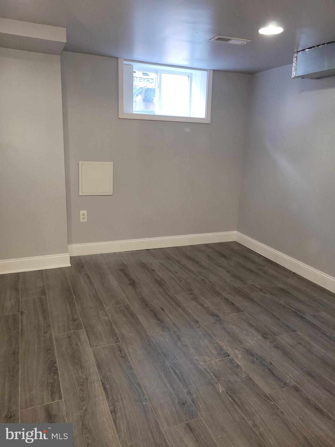 917 North Rose Street Baltimore, MD 21205 - Photo 29 of 34 a view of an empty room with wooden floor and a window