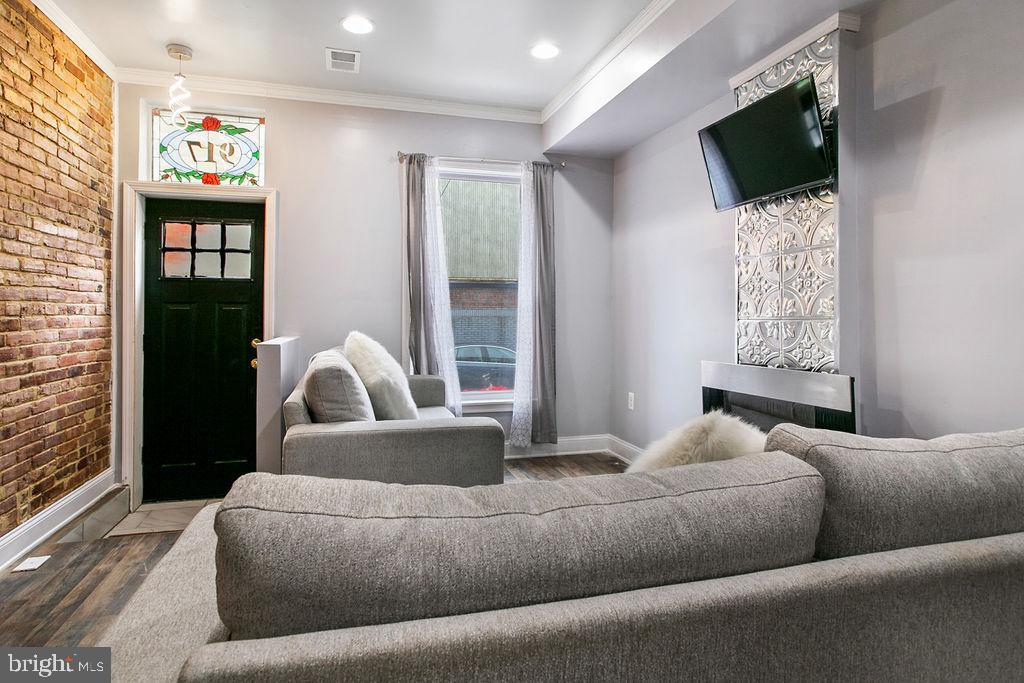 917 North Rose Street Baltimore, MD 21205 - Photo 6 of 34 a living room with furniture a flat screen tv and a window