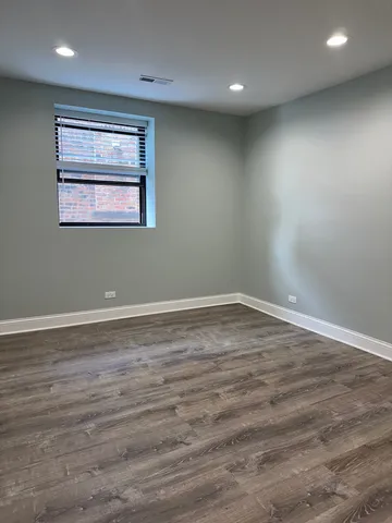 a porch with a bench and potted plants