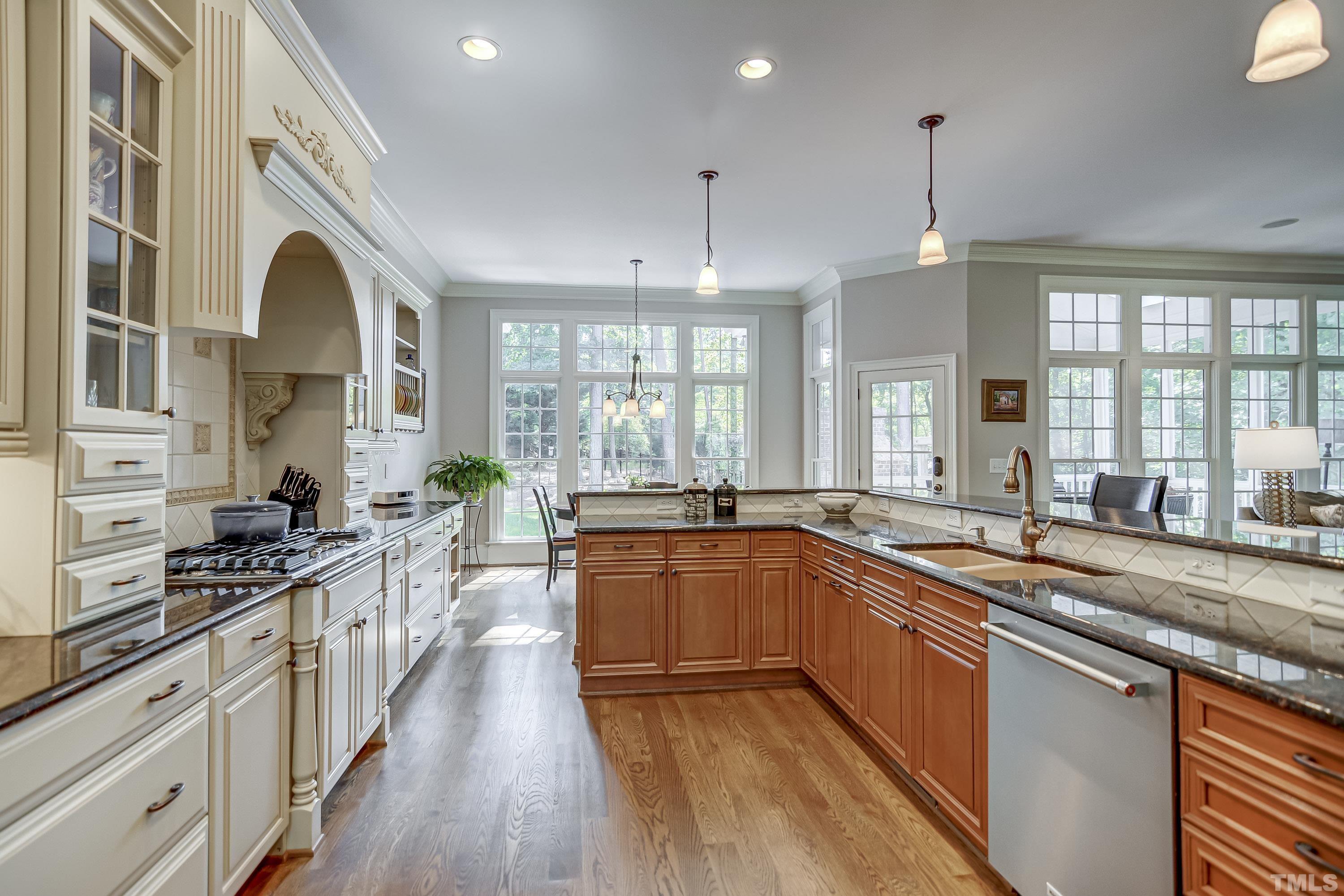 1520 Consett Court Raleigh, NC 27613 - Photo 8 of 30 a large kitchen with stainless steel appliances granite countertop a stove and a sink