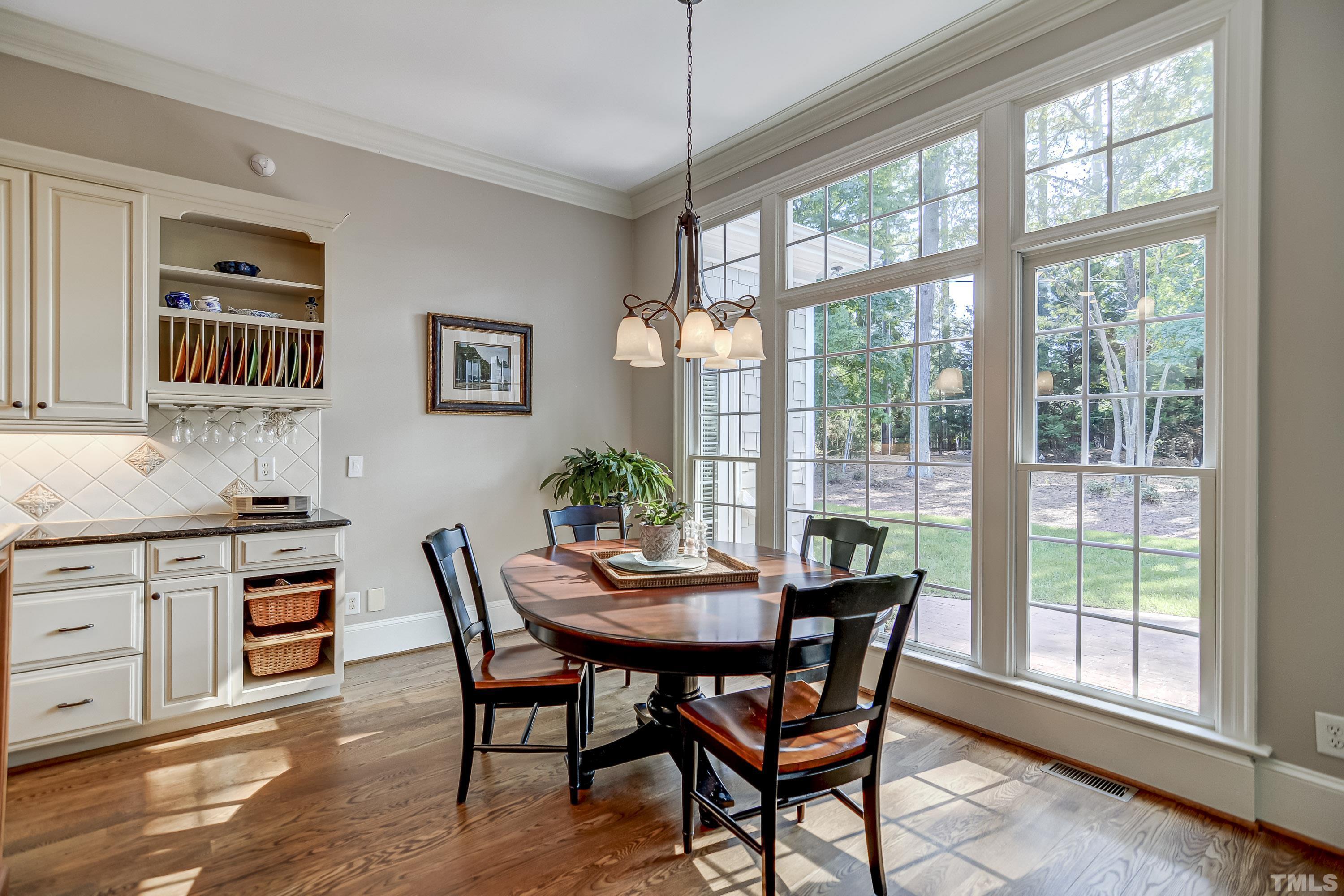 1520 Consett Court Raleigh, NC 27613 - Photo 9 of 30 a dining room with furniture a chandelier and wooden floor