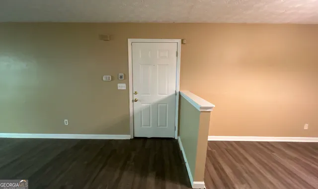 a view of a room with wooden floor