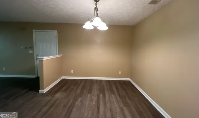 a view of a room with wooden floor and a window