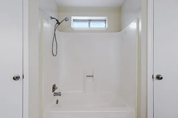 a bathroom with a bathtub and a shower