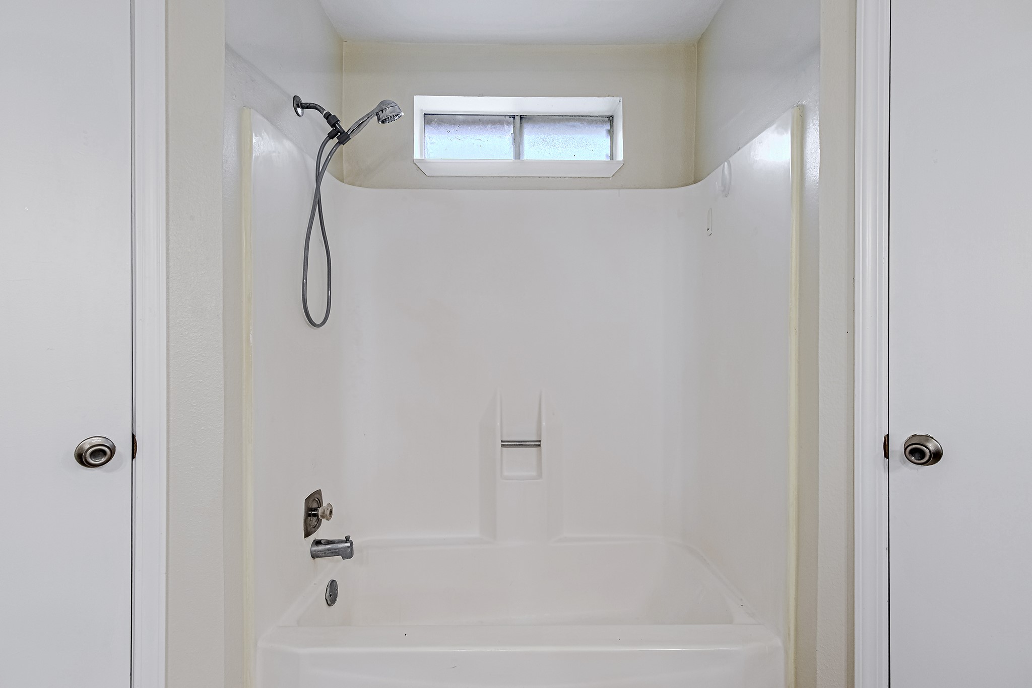 17811 Hawk Haven Lane Spring, TX 77379 - Photo 16 of 24 Tub/shower combination in the primary en suite, positioned between separate his-and-hers closets for a practical and well-designed layout.