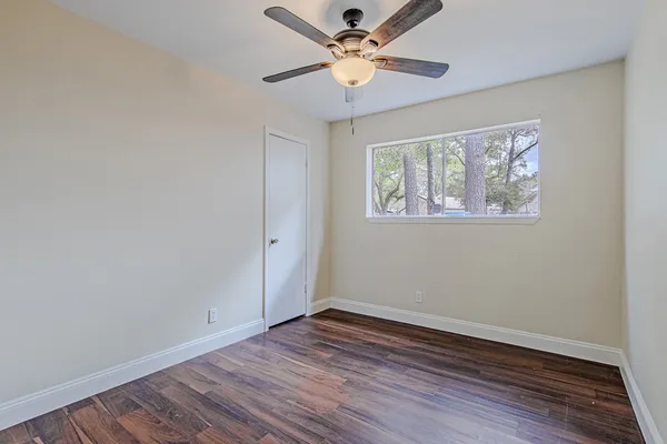 wooden floor in an empty room with a window
