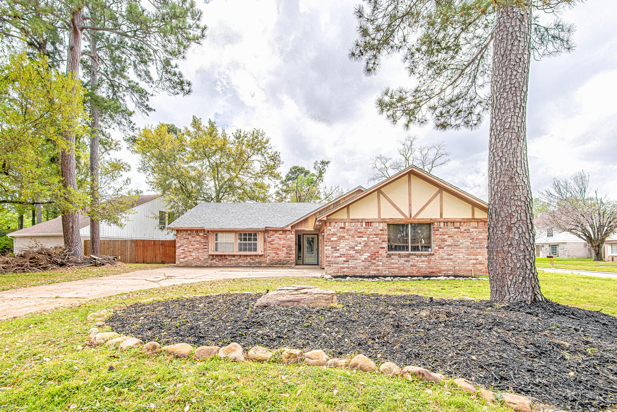 17811 Hawk Haven Lane Spring, TX 77379 - Photo 22 of 24 Exterior shown in its original aesthetic prior to the paint transformation currently underway, highlighting the home’s spacious corner-lot setting, mature trees, and placement within a small cul-de-sac just a very short walk from the neighborhood park and walking trail.