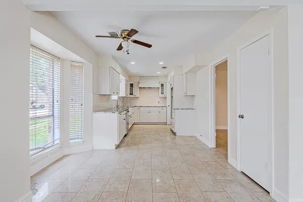 a view of a kitchen with a sink and windows