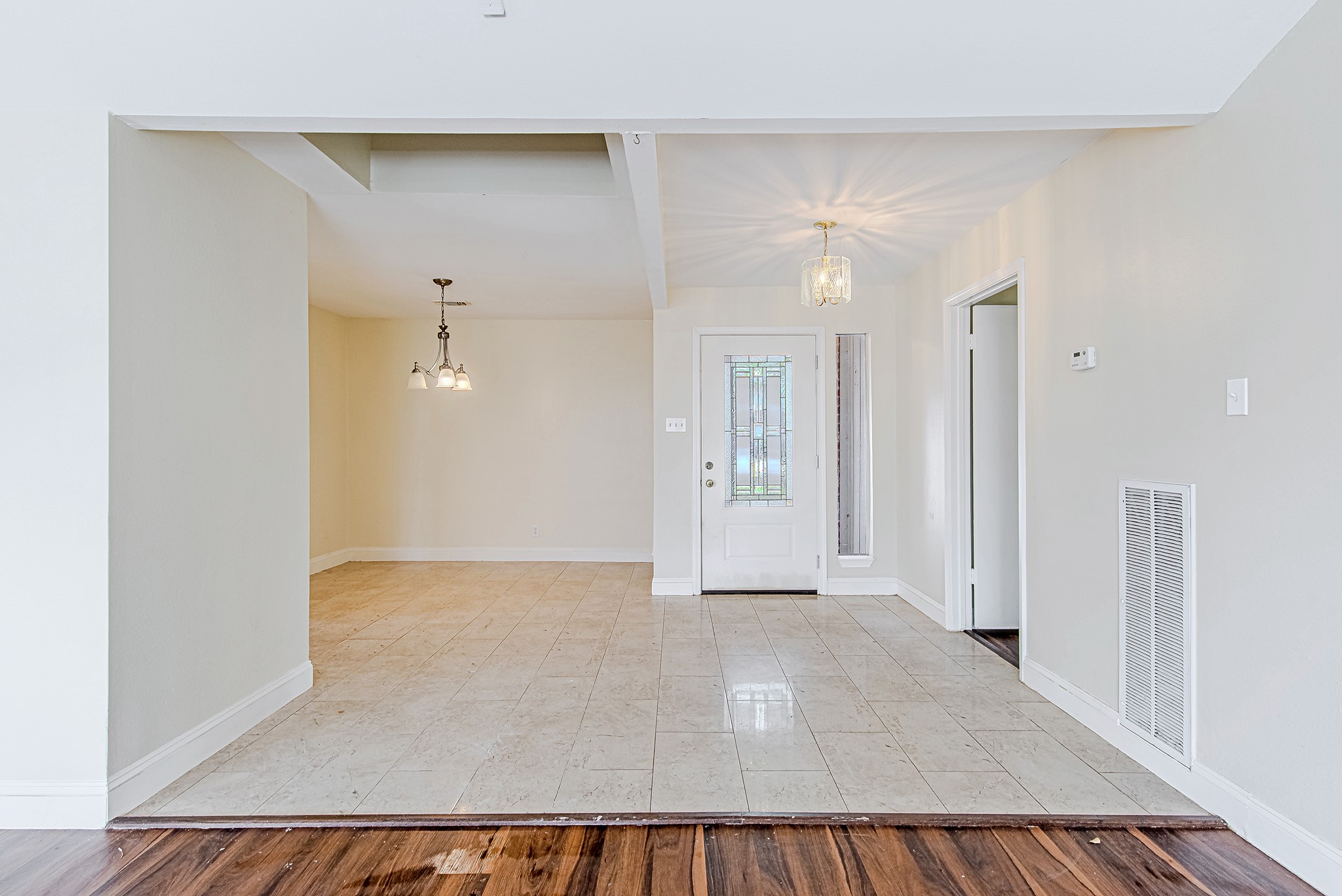 17811 Hawk Haven Lane Spring, TX 77379 - Photo 5 of 24 Welcoming entry with tile flooring, a decorative glass front door, and an open flow into the dining area. Updated entryway and dining room light fixtures have been installed since this photo was taken.