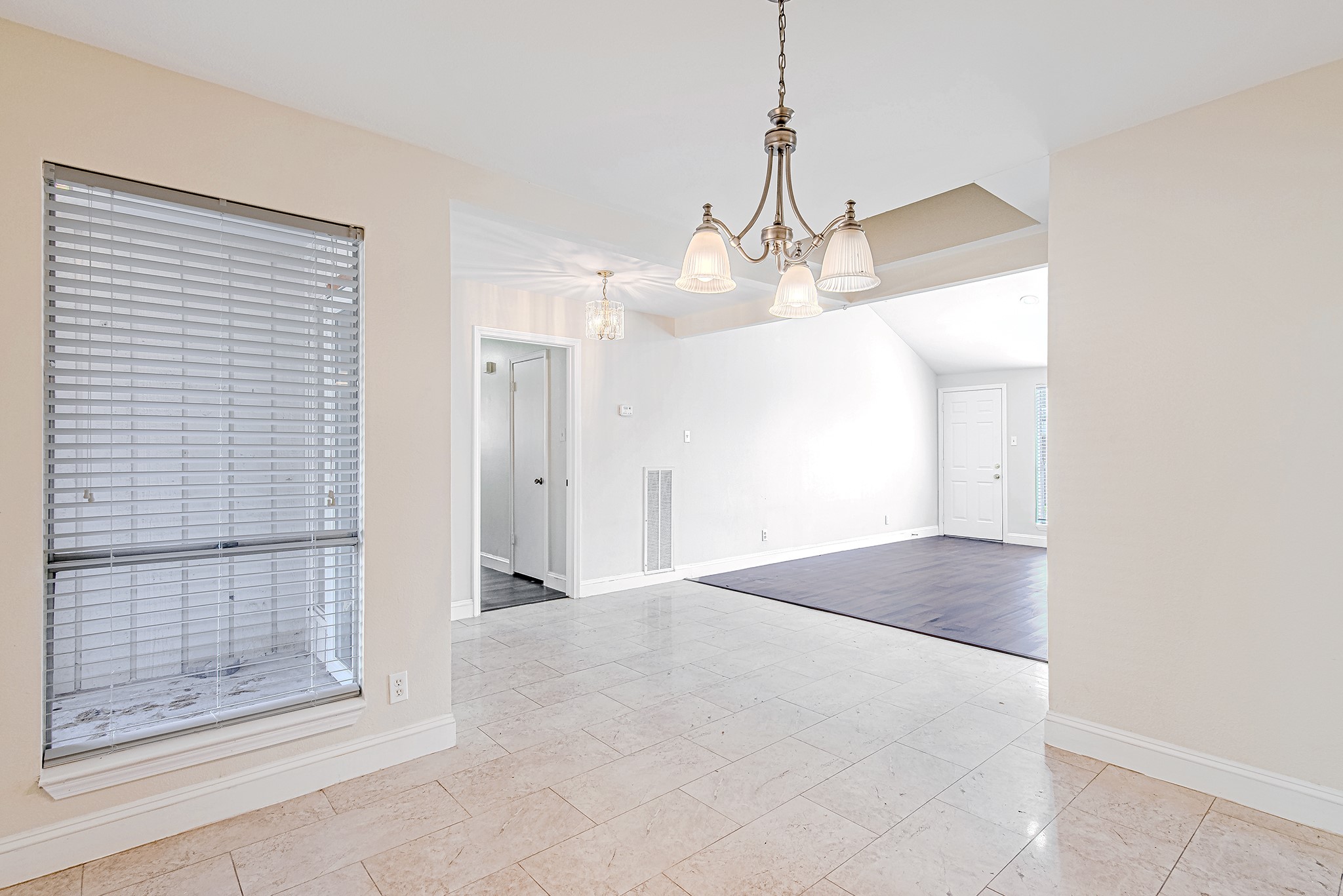 17811 Hawk Haven Lane Spring, TX 77379 - Photo 7 of 24 From the dining room, this view opens to the living area and highlights the home’s easy, connected layout, while the nearby hallway provides access to the bedroom wing.