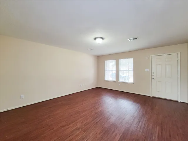 a view of a room with rack on the wall and a window