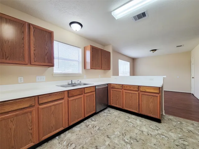 a kitchen with a sink cabinets and window