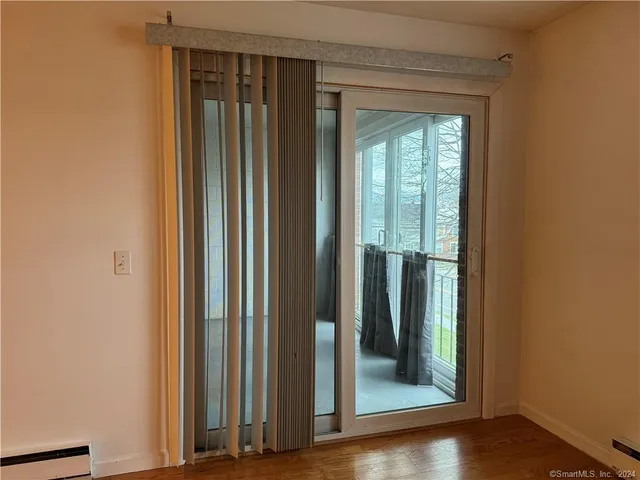a view of a front door and wooden floor