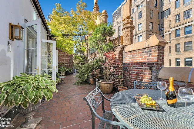a view of balcony with chairs and potted plants