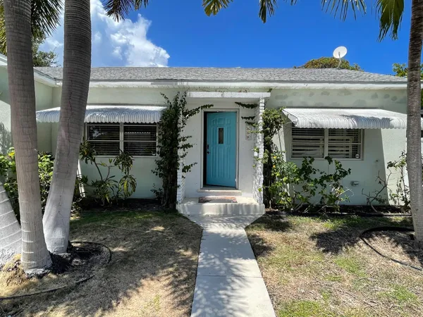 a view of a house with potted plants