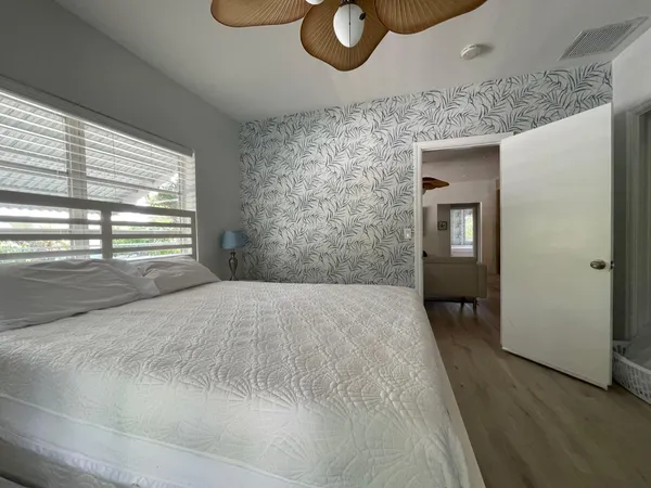 a bedroom with a bed and a window