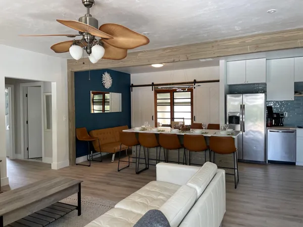 a living room with lots of furniture and chandelier