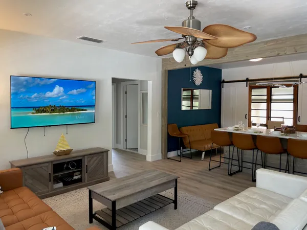 a living room with furniture a rug and a flat screen tv