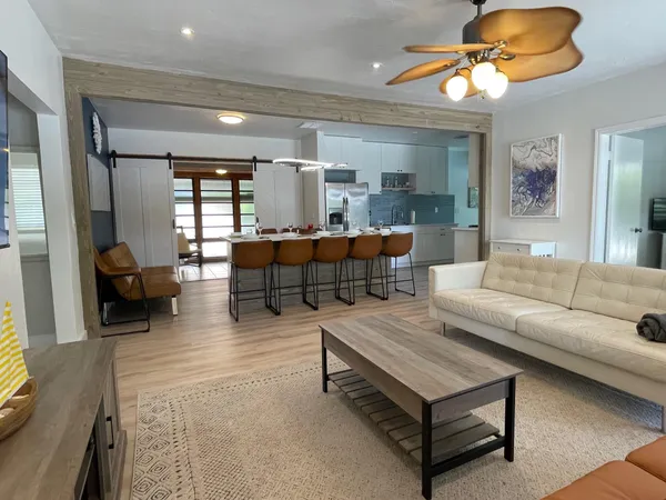 a living room with furniture a rug and a chandelier