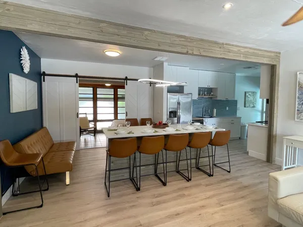 a living room with dining room and wooden floor