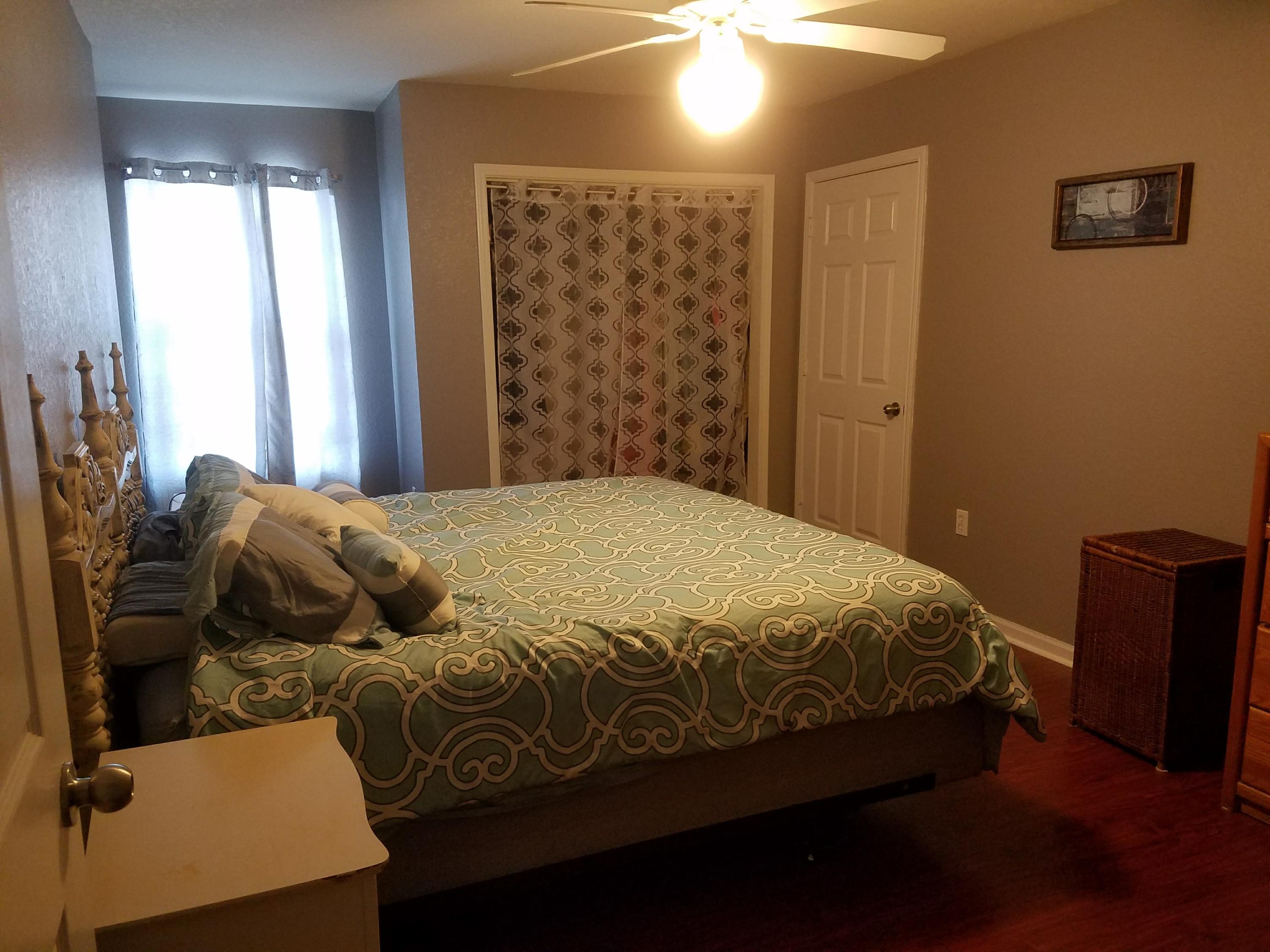 1014 Airport Road, Unit 105 Destin, FL 32541 - Photo 12 of 25 a bedroom with a bed and a window