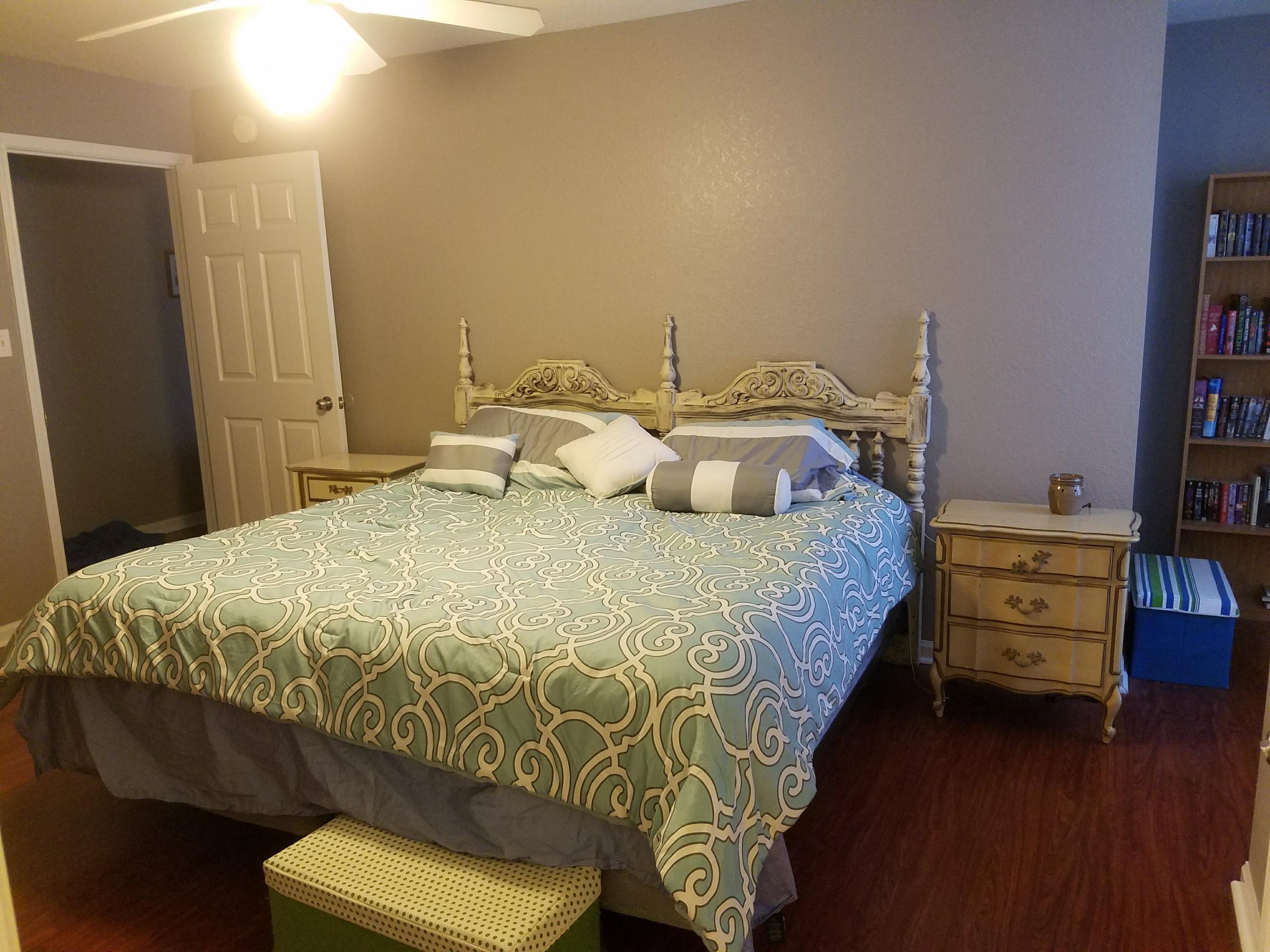 1014 Airport Road, Unit 105 Destin, FL 32541 - Photo 14 of 25 a bedroom with a bed and a book shelf