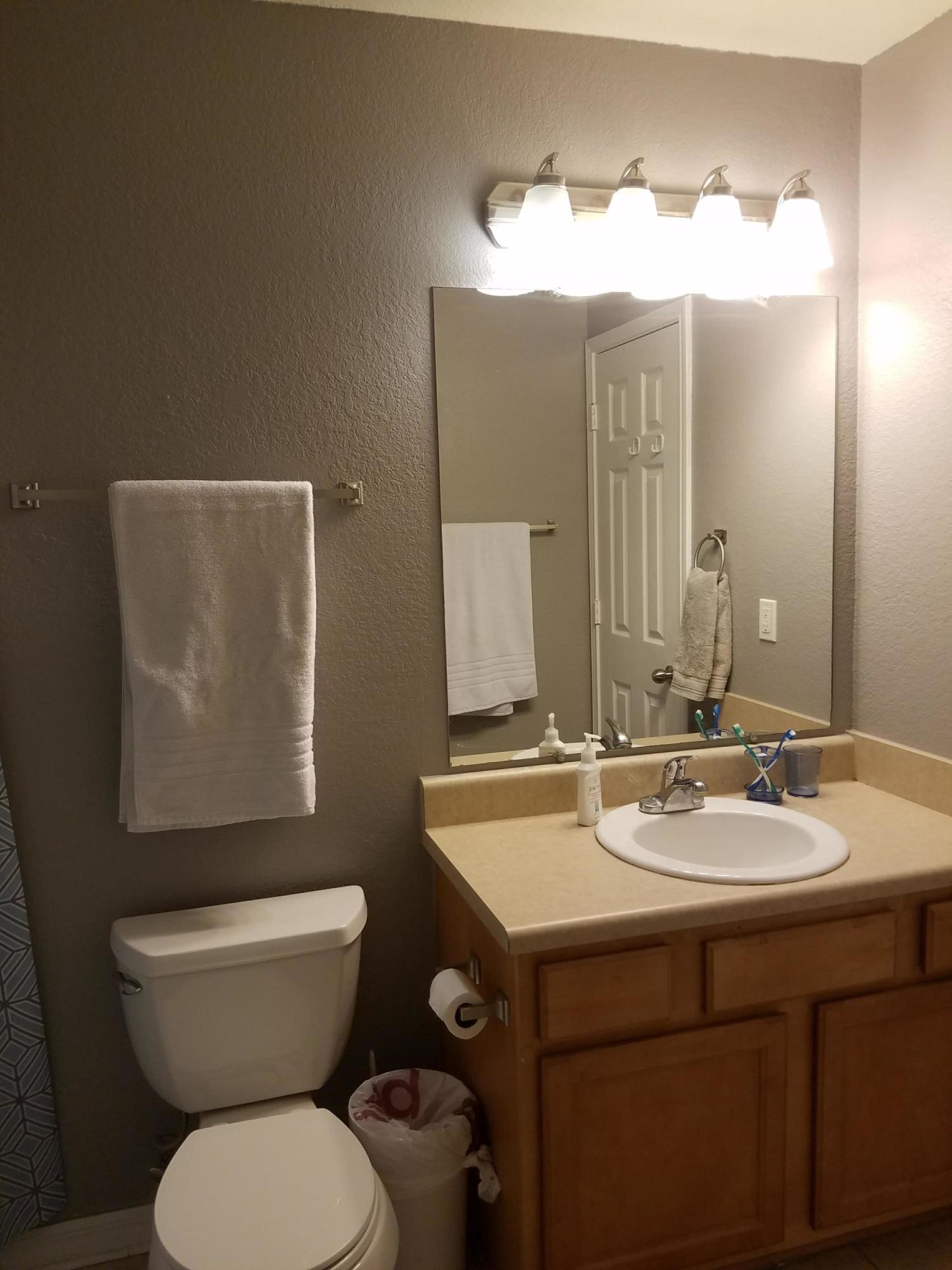1014 Airport Road, Unit 105 Destin, FL 32541 - Photo 15 of 25 a bathroom with a toilet sink and mirror
