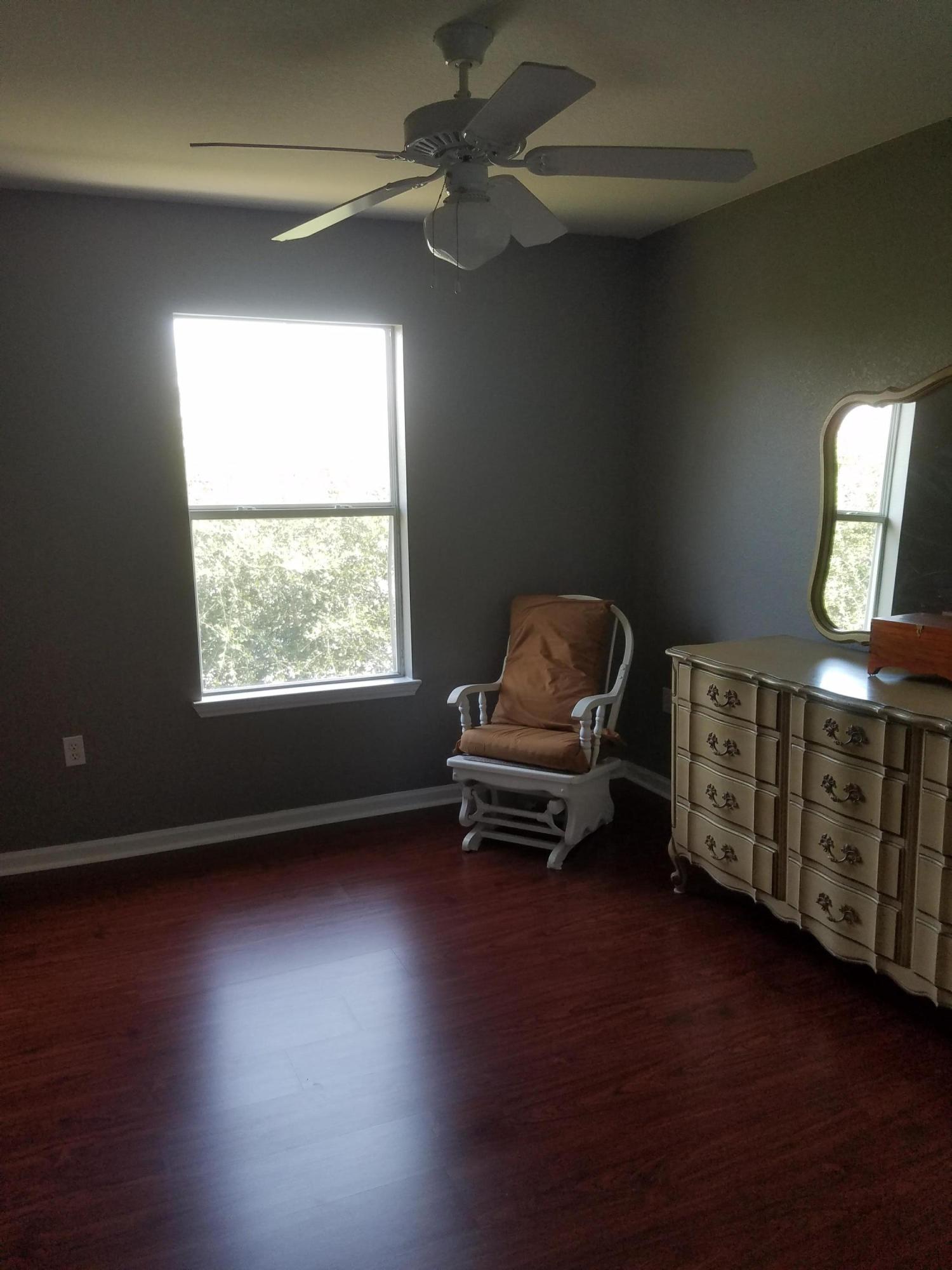1014 Airport Road, Unit 105 Destin, FL 32541 - Photo 20 of 25 a living room with furniture a window and a wooden floor