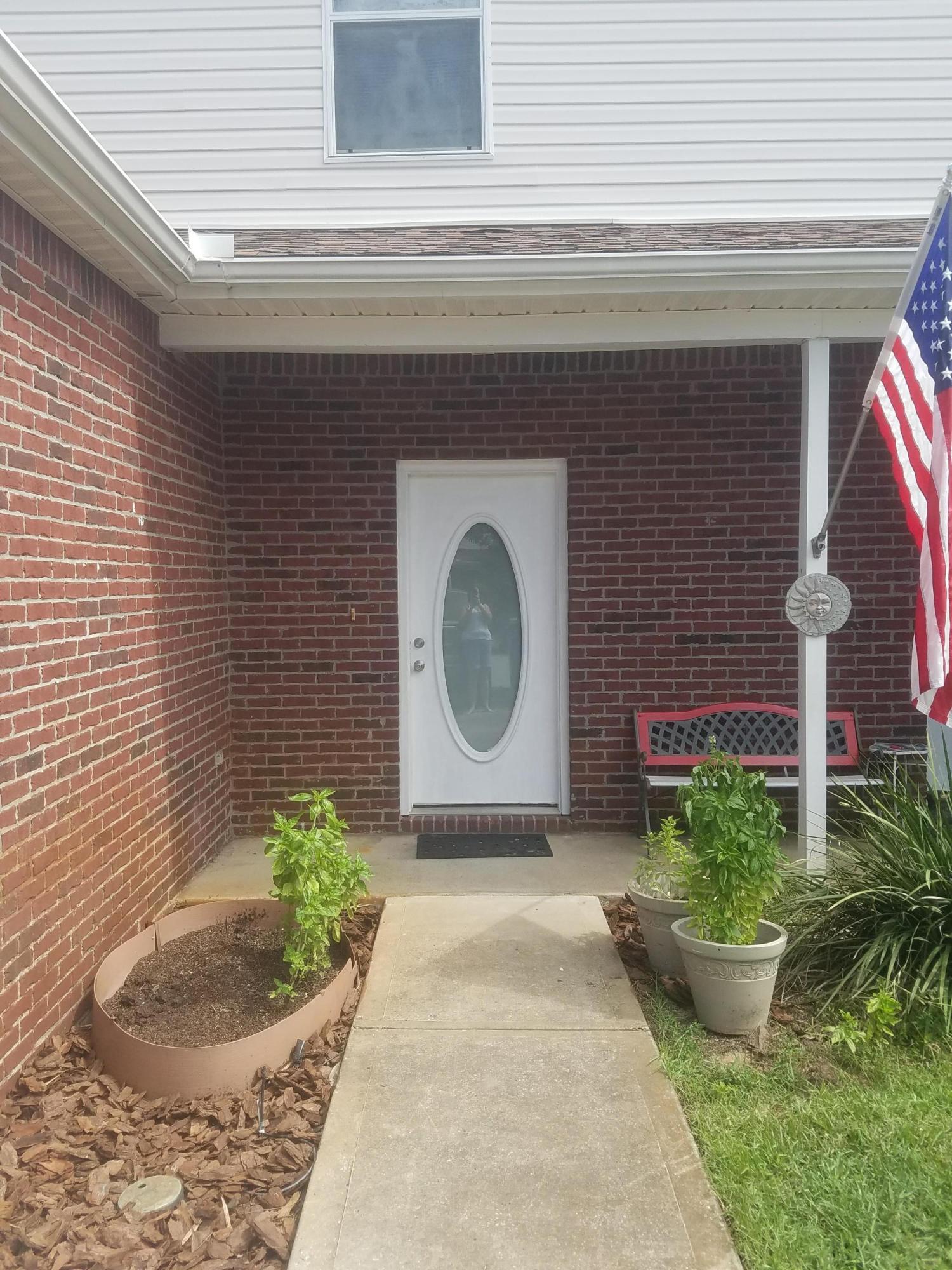 1014 Airport Road, Unit 105 Destin, FL 32541 - Photo 2 of 25 a front view of a house with a garden