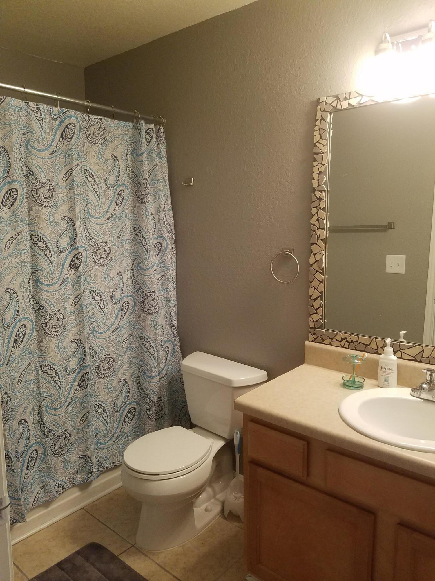 1014 Airport Road, Unit 105 Destin, FL 32541 - Photo 23 of 25 a bathroom with a sink and a toilet