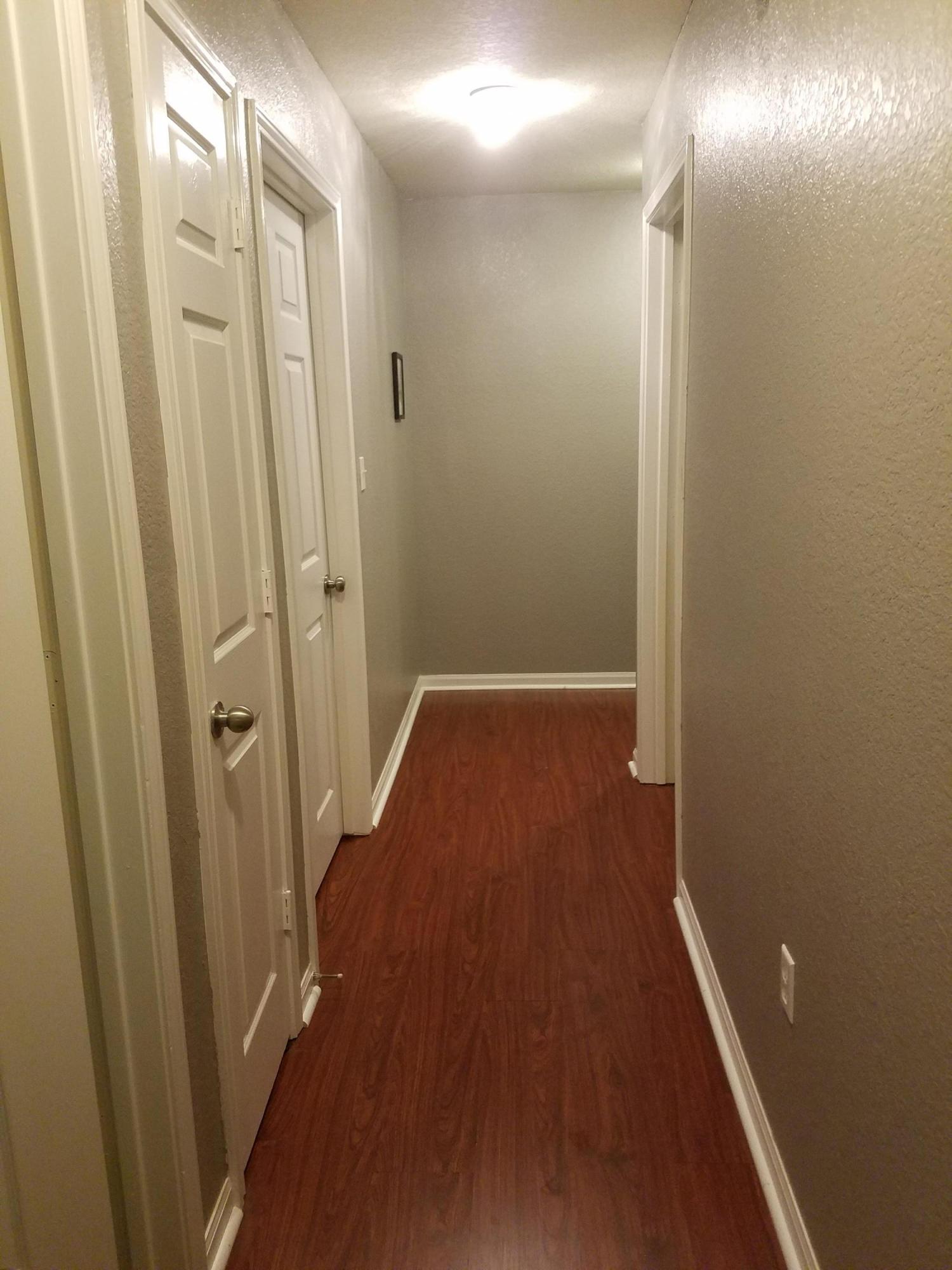 1014 Airport Road, Unit 105 Destin, FL 32541 - Photo 25 of 25 a view of a hallway with wooden floor
