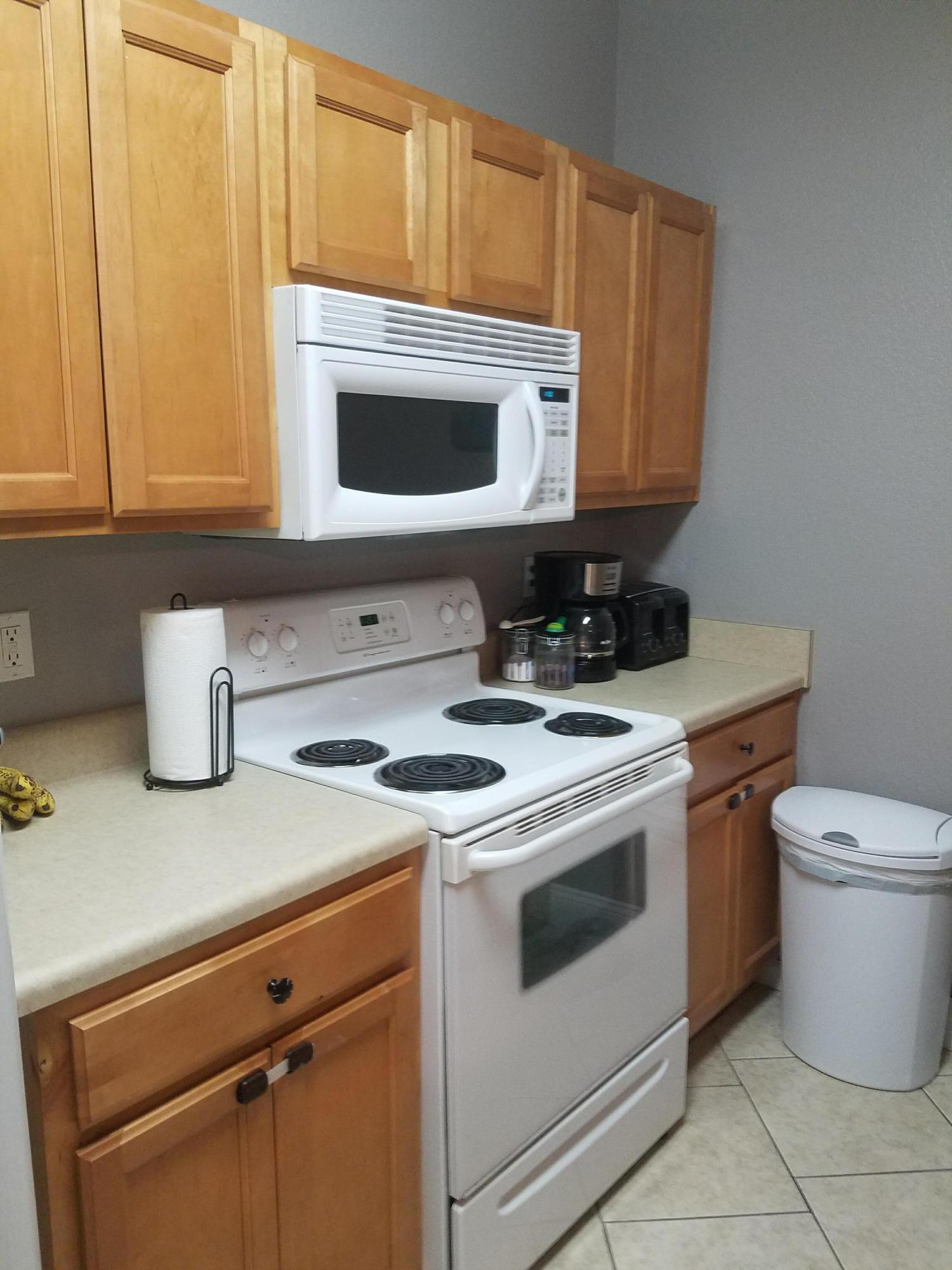 1014 Airport Road, Unit 105 Destin, FL 32541 - Photo 4 of 25 a kitchen with a stove and a microwave