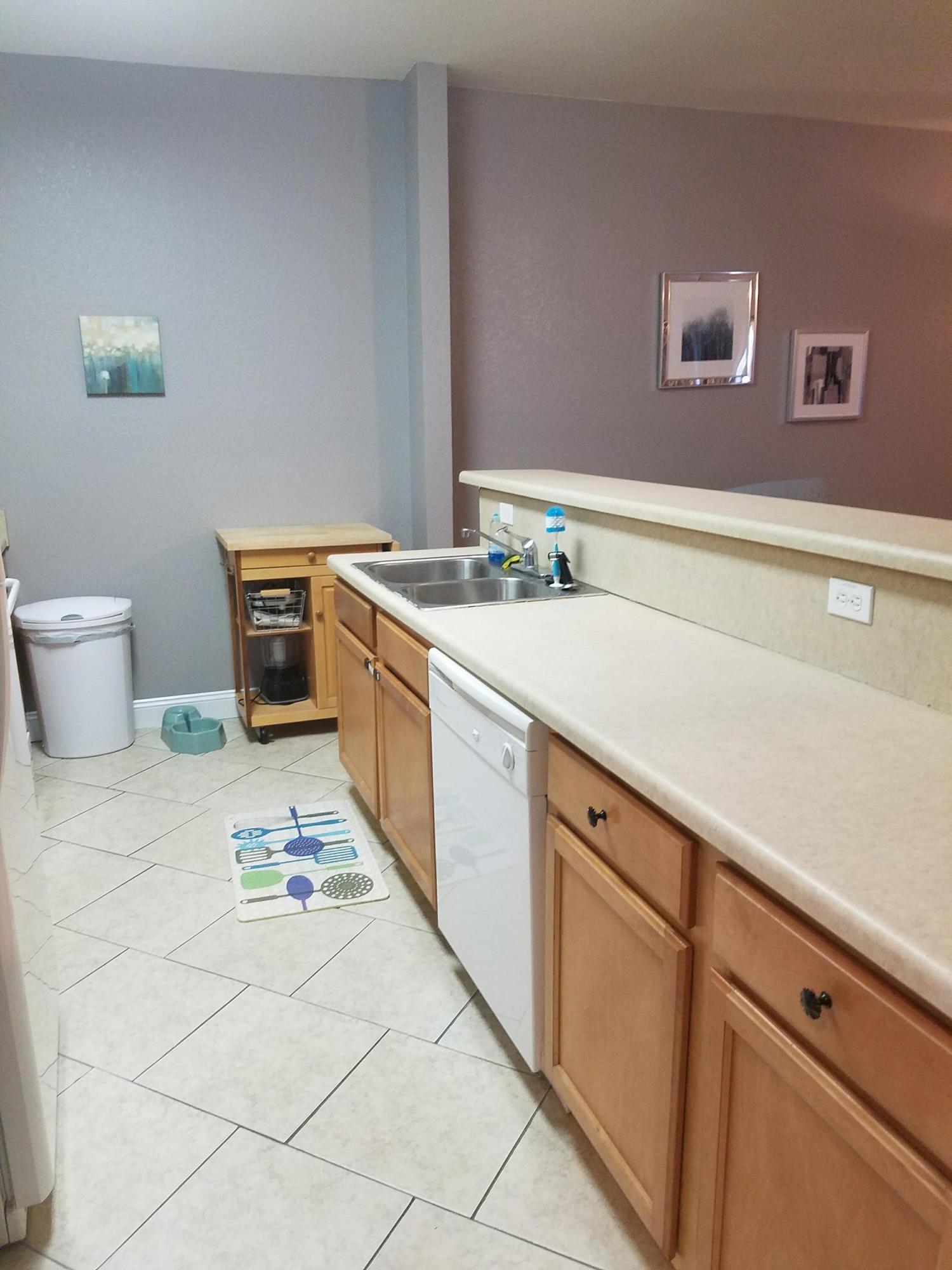 1014 Airport Road, Unit 105 Destin, FL 32541 - Photo 5 of 25 a kitchen with a sink and cabinets