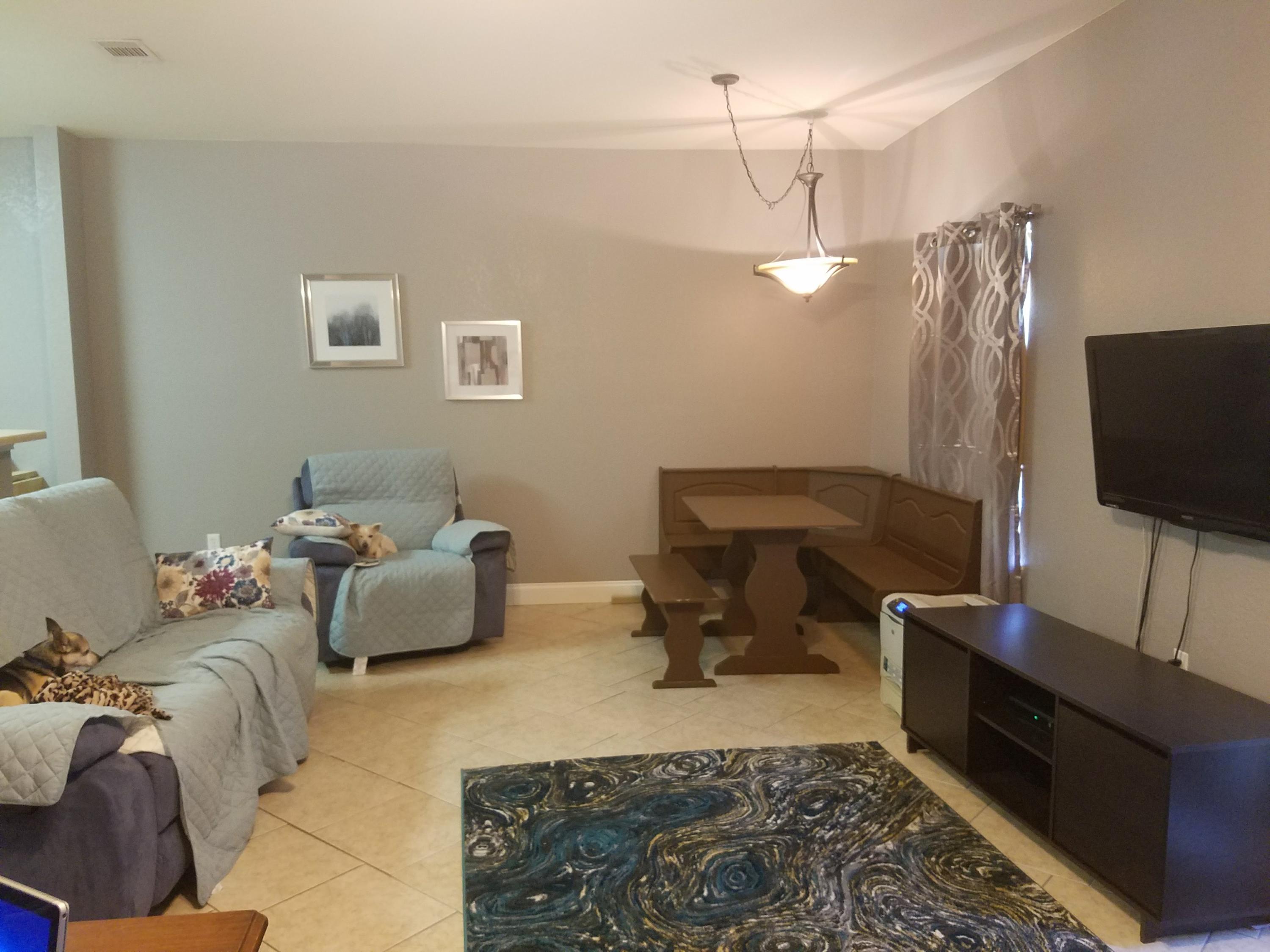 1014 Airport Road, Unit 105 Destin, FL 32541 - Photo 7 of 25 a living room with furniture and a flat screen tv