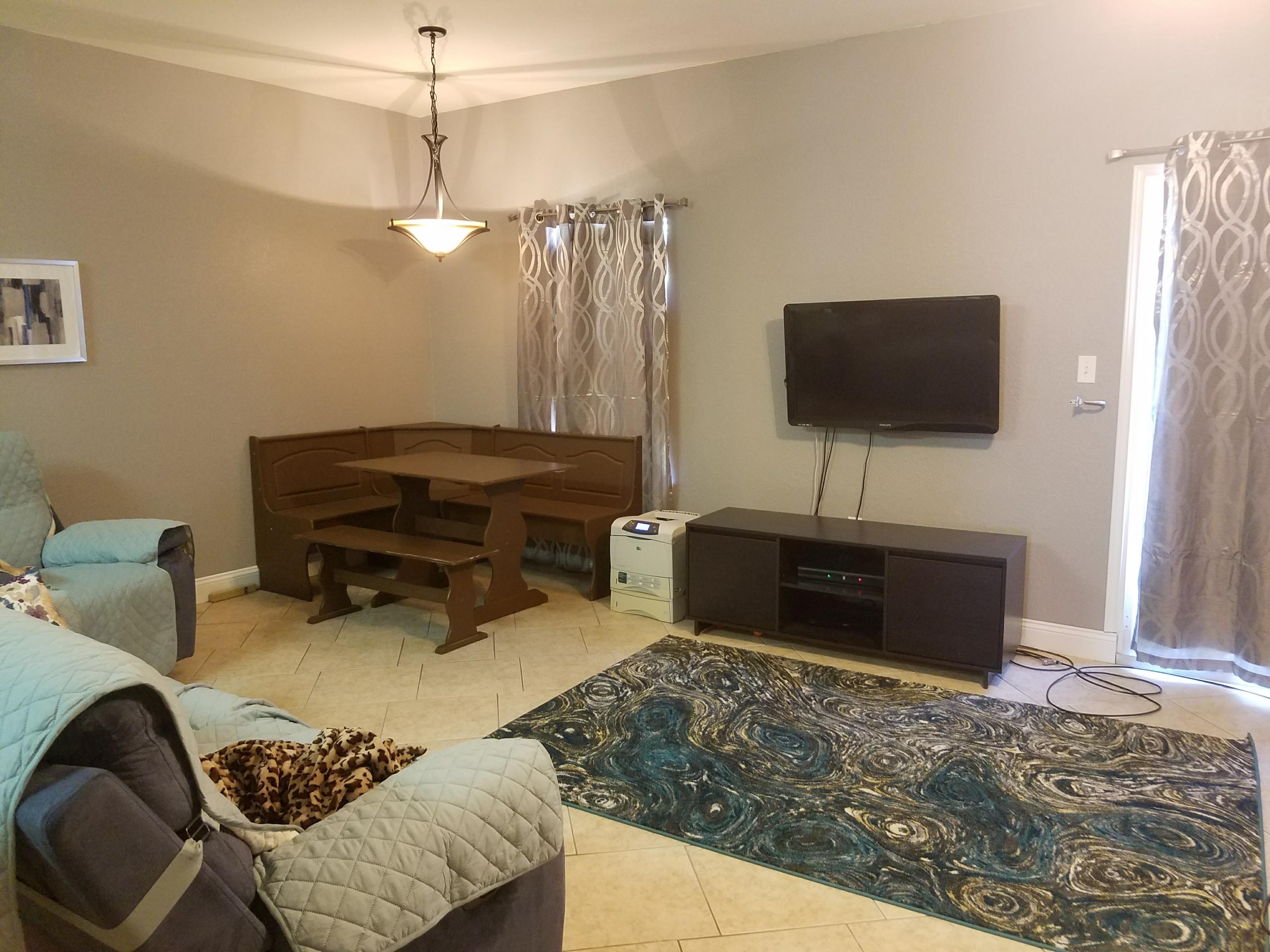 1014 Airport Road, Unit 105 Destin, FL 32541 - Photo 8 of 25 a living room with furniture and a flat screen tv