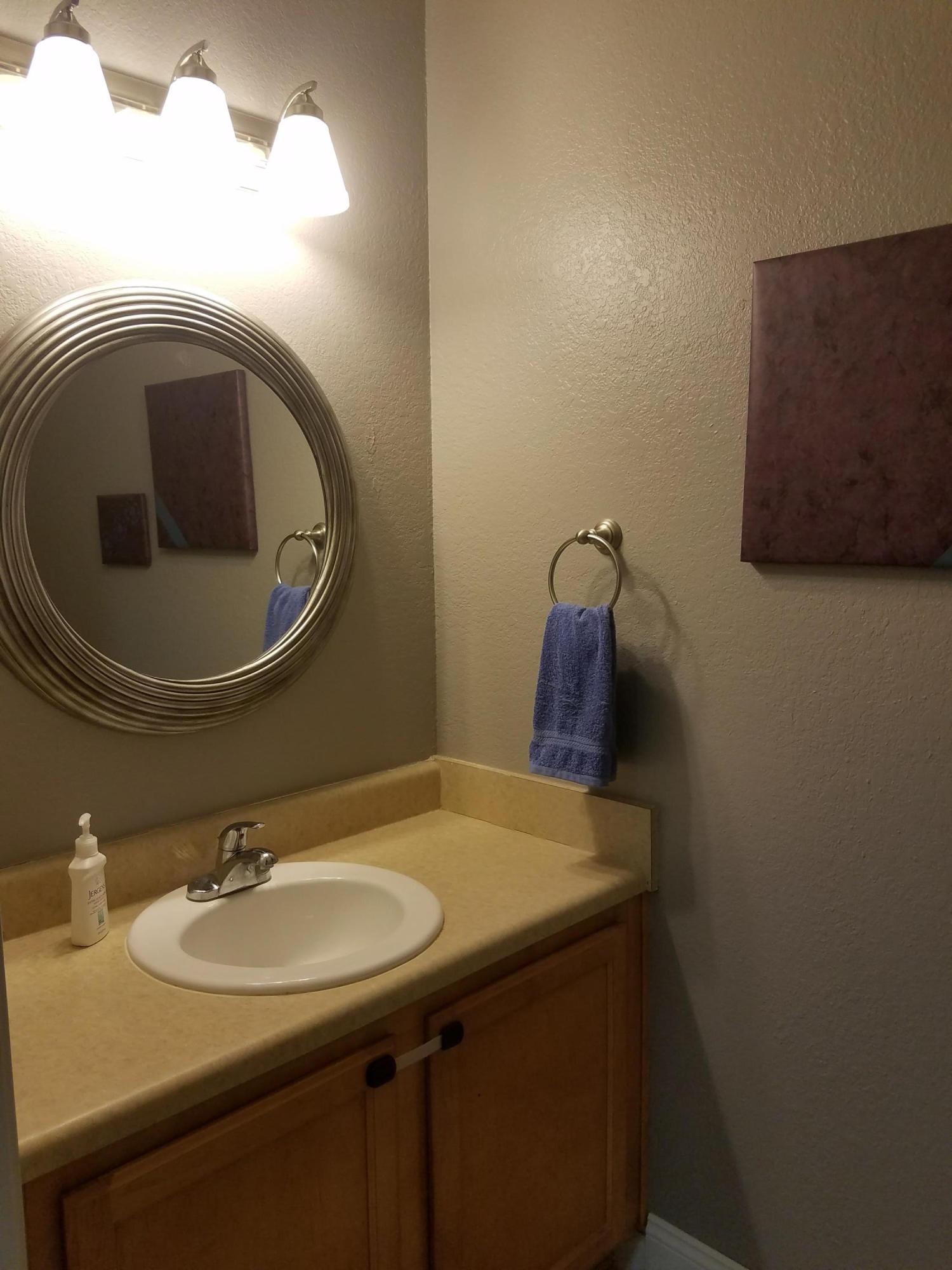 1014 Airport Road, Unit 105 Destin, FL 32541 - Photo 9 of 25 a bathroom with a sink and a mirror